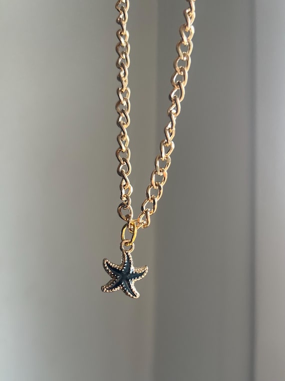Golden necklace with black starfish charm pendant adjustable length beach