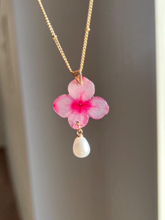 Necklace pendant made of a real light pink hydrangea flower with gold clasp and white pearl