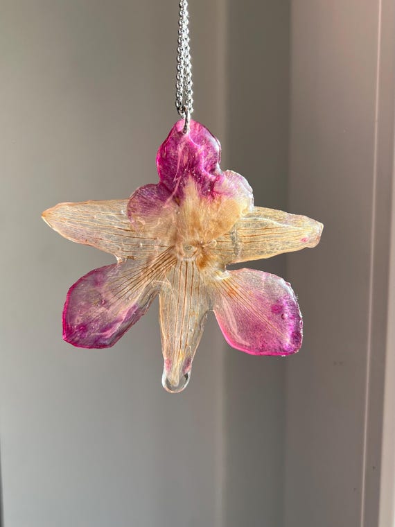 Necklace pendant made of a real orchid flower in pink and white with silver clasp