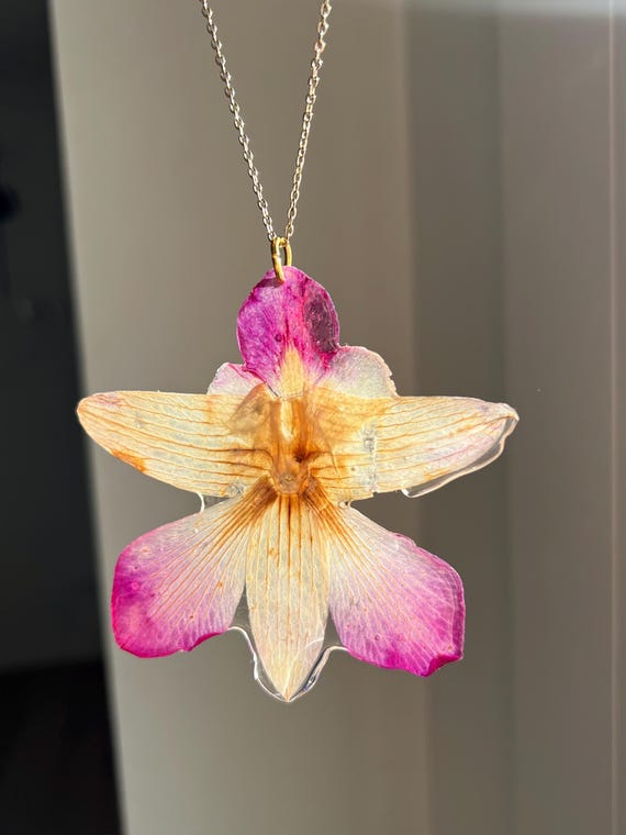 Necklace pendant made of a real orchid flower in pink and white with gold clasp