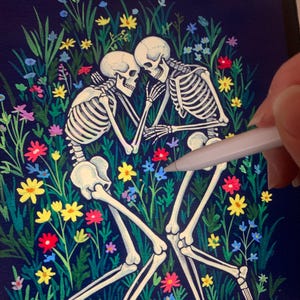 May include: Two skeletons are lying in a field of colorful flowers. The skeletons are embracing each other, with their arms wrapped around each other's waists. The flowers are a variety of colors, including red, yellow, blue, and pink. The background is a dark blue.