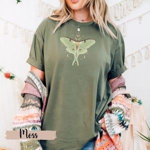 Moss green T-shirt with luna moth and crescent moon and celestial stars