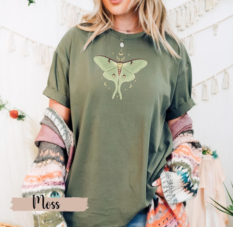 Moss green T-shirt with luna moth and crescent moon and celestial stars