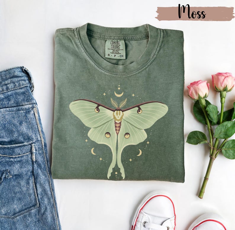 Moss green T-shirt with luna moth and crescent moon and celestial stars
