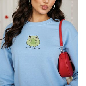 Frog flipping the bird with the text i hate all of you in black below Embroidered Sweatshirt Funny Frog Gift Goblincore Frog Lover Gift Cool Frog Outfit Frog Retro Meme Green Frog Embroidered Crewneck