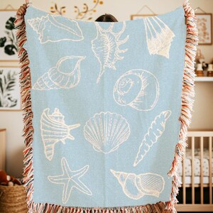 light blue blanket with white seashells, vintage sealife coastal decor nautical theme tapestry