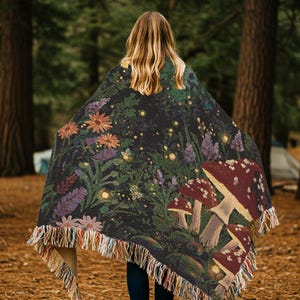 Woven blanket with a enchanted woodland whimsy scene with toadstool mushrooms wildflowers fireflies moths and trees nighttime scene cottagecore witchy tapestry