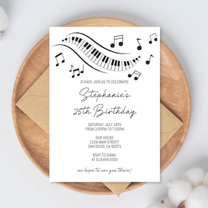 May include: A white invitation card with a musical theme, featuring a piano keyboard design and musical notes. The text reads "Stephanie's 25th Birthday" with event details. The card is on a wooden plate with a brown envelope.