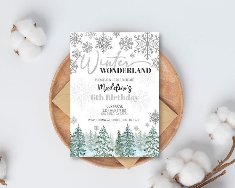 May include: A white invitation with silver glitter text that reads "Winter Wonderland" and "Madeline's 6th Birthday". The invitation features a snowy forest scene with pine trees and snowflakes.