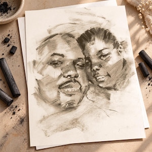 May include: A charcoal drawing on off-white paper depicting the portraits of two individuals positioned closely together. The artwork features expressive, loose shading and dark strokes that define the facial features, expressions, and hair textures.