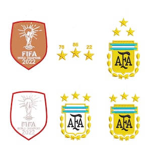 May include: A gold and blue embroidered patch featuring the text "AFA" and a laurel wreath. The patch is surrounded by four gold stars. The text "FIFA World Champions 2022" is also included in the image.