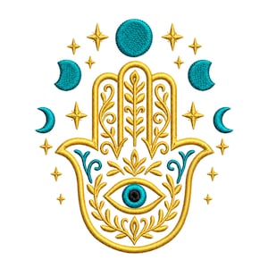 May include: An embroidered hamsa hand design featuring a central eye with a blue iris and black pupil. The hand is outlined in gold thread with intricate leaf and vine patterns. Surrounding the hand are teal crescent moons and gold stars.