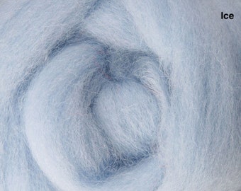 May include: Close-up of a mass of light blue wool roving, with the word "Ice" in the upper right corner. The wool fibers are soft and fluffy, creating a textured appearance. The color is a pale, icy blue.
