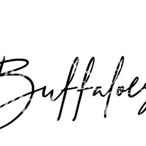 May include: Black and white handwritten text that reads "Buffaloes" with a small heart drawn to the right of the text.