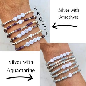 Stacked stretch beaded bracelets with gold-tone and pale-blue beads; white alphabet beads spell names for a personalized kids name bracelet set.