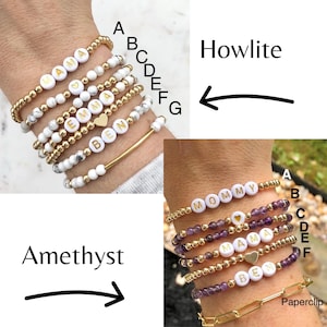 Stacked stretch beaded bracelets with gold-tone and pale-blue beads; white alphabet beads spell names for a personalized kids name bracelet set.