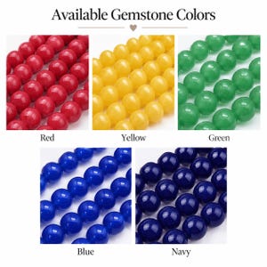 May include: A collection of round gemstone beads displayed in five color variations labeled Available Gemstone Colors. The colors include red, yellow, green, blue, and navy. Each section shows multiple rows of smooth, polished spherical beads.