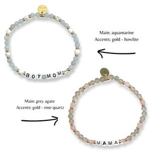 May include: Two beaded bracelets. One is aquamarine with gold accents and the text "BOY MOM". The other is grey agate with gold and rose quartz accents and the text "MAMA". Both bracelets have a gold charm.