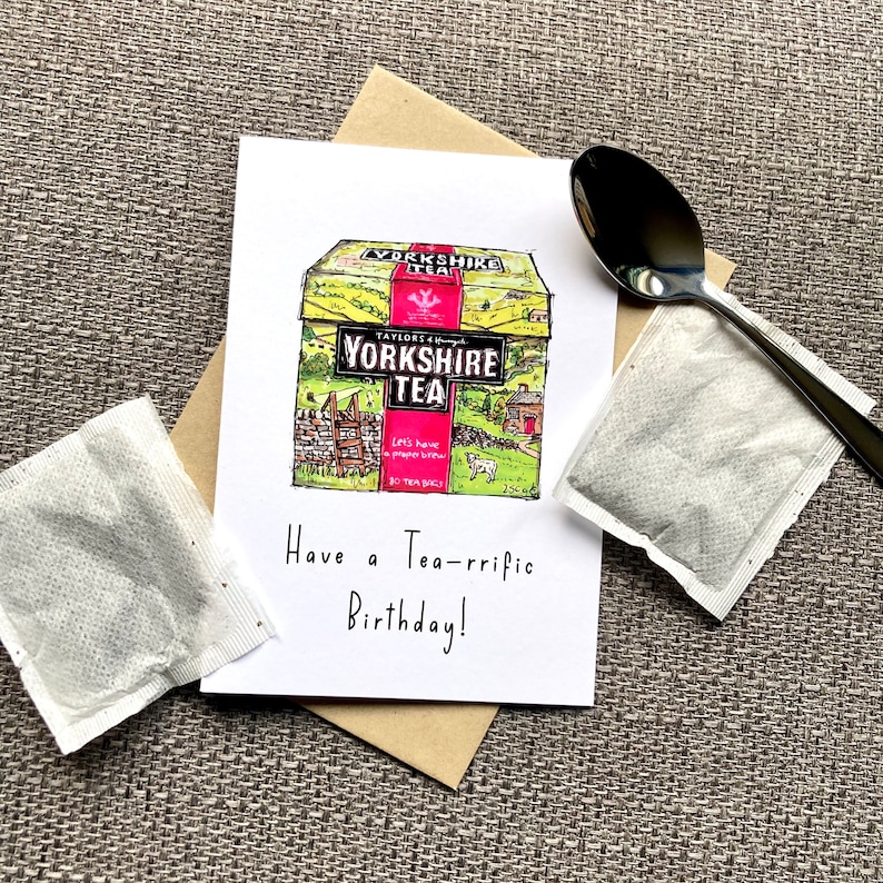 May include: A birthday card with a hand-drawn illustration of a box of Yorkshire Tea. The card has the text "Have a Tea-rrific Birthday!" on it.