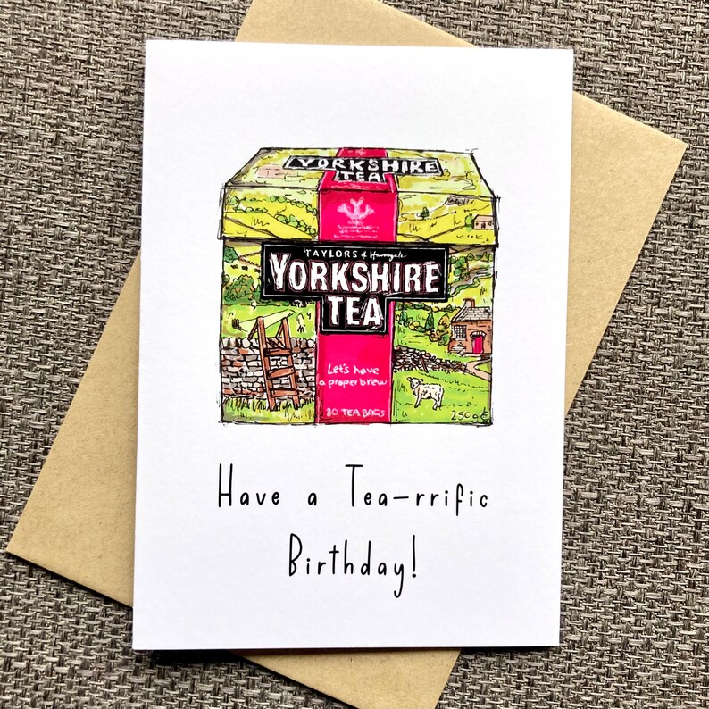 May include: A birthday card featuring a cartoon illustration of a box of Yorkshire Tea with the text "Let's have a proper brew" and "80 tea bags". The card has the text "Have a Tea-rrific Birthday!" written below the illustration.
