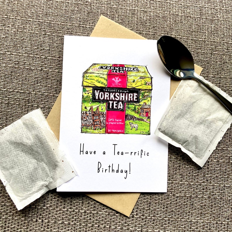 May include: A birthday card with a hand-drawn illustration of a box of Yorkshire Tea. The card reads "Have a Tea-rrific Birthday!"