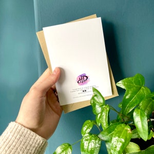 May include: Back of a greeting card with a watercolor design of a pink, purple, and blue abstract shape. The card is printed with the text "Printed from an original drawing. Created from an old finish in my studio. @hiddensplystudio www.etsy.com/shop/hiddensplystudio"