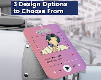 May include: A pink and purple luggage tag with a cartoon illustration of a person. The tag has a music player design with the text "Seven (feat. Latto) Jungkook, Latto".