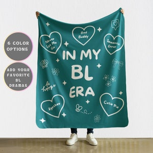 May include: Teal blue throw blanket with white text that reads "In My BL Era" and various white heart-shaped designs with text such as "Bad Buddy", "Semantic Error", "Never Let Me Go", "Cutie Pie", "Be Happy", and "2gether".