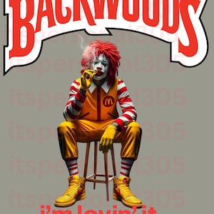 May include: A clown wearing a red wig and a yellow and red striped outfit sits on a stool, smoking a cigarette. The background features the words "Backwoods" in red and white. The text "i'm lovin' it" is written in red below the clown.