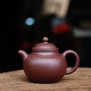 May include: A handmade, wooden cutting board with a natural finish. The rectangular board features a juice groove and a handle. Dimensions are approximately 18 inches long, 12 inches wide, and 1 inch thick.