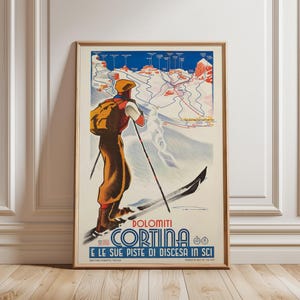 May include: A vintage-style travel poster featuring a skier in a yellow cap, red jacket, and brown trousers looking out over a blue and white map of the Dolomiti Cortina ski slopes. The text reads DOLOMITI CORTINA E LE SUE PISTE DI DISCESA IN SCI.