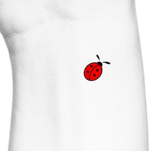May include: A red ladybug with black spots and antennae on a white background.