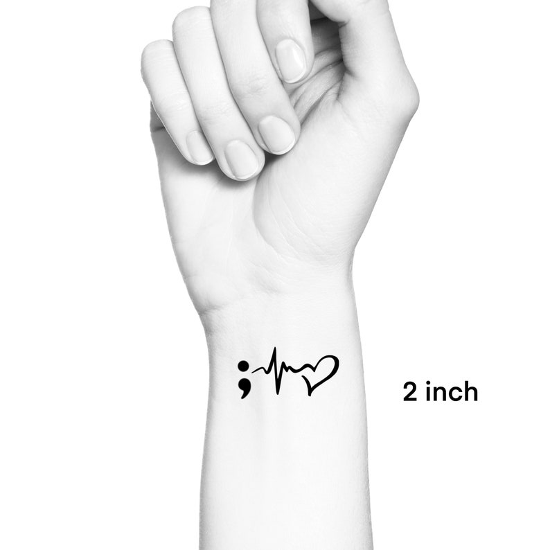 May include: Black and white temporary tattoo featuring a semicolon, a heartbeat, and a heart. The tattoo measures 2 inches.