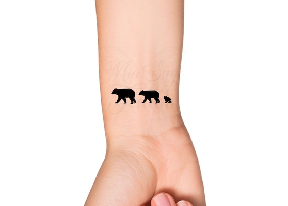 Small polar bear tattoo on the right inner ankle