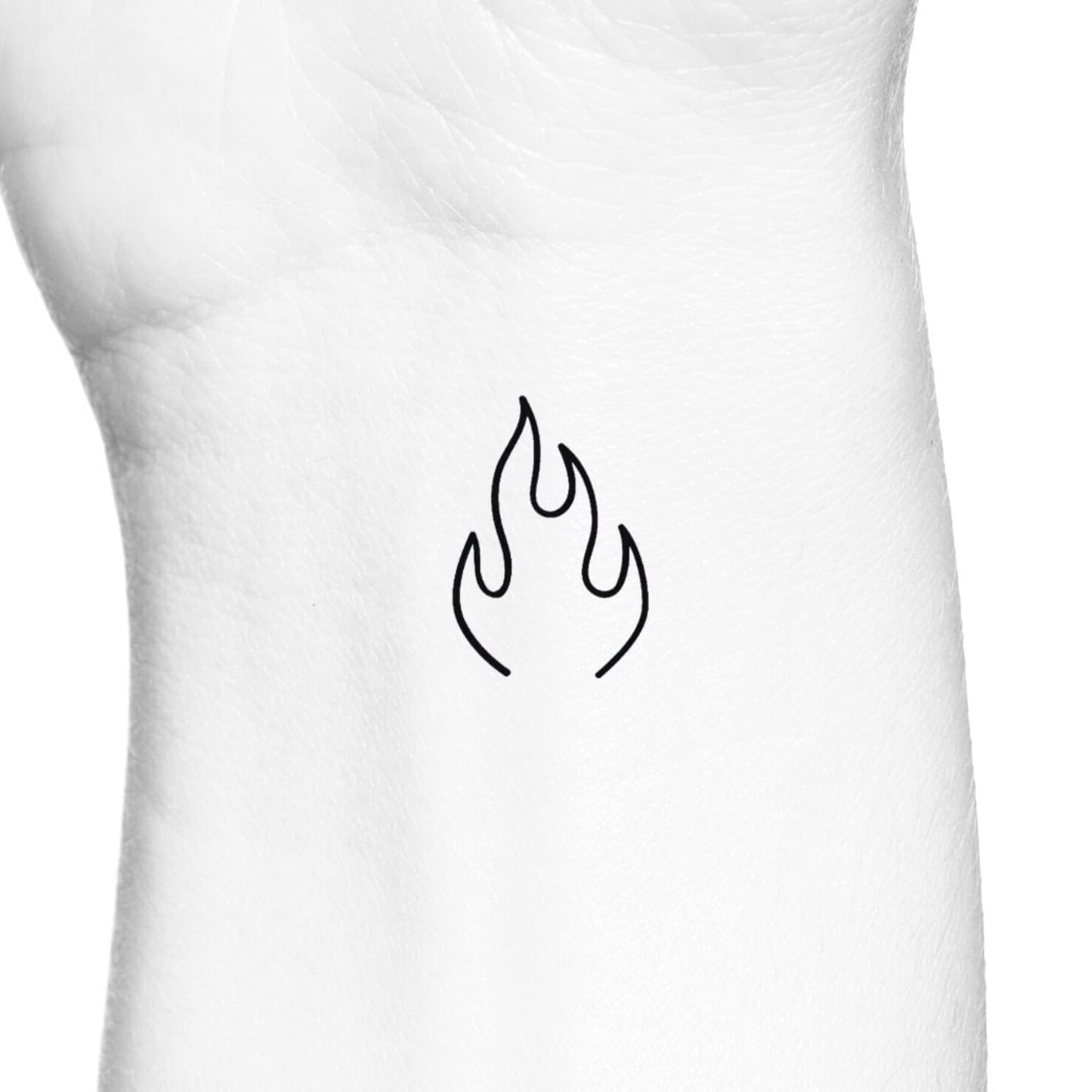 Hand poked minimalist fire tattoo on the wrist
