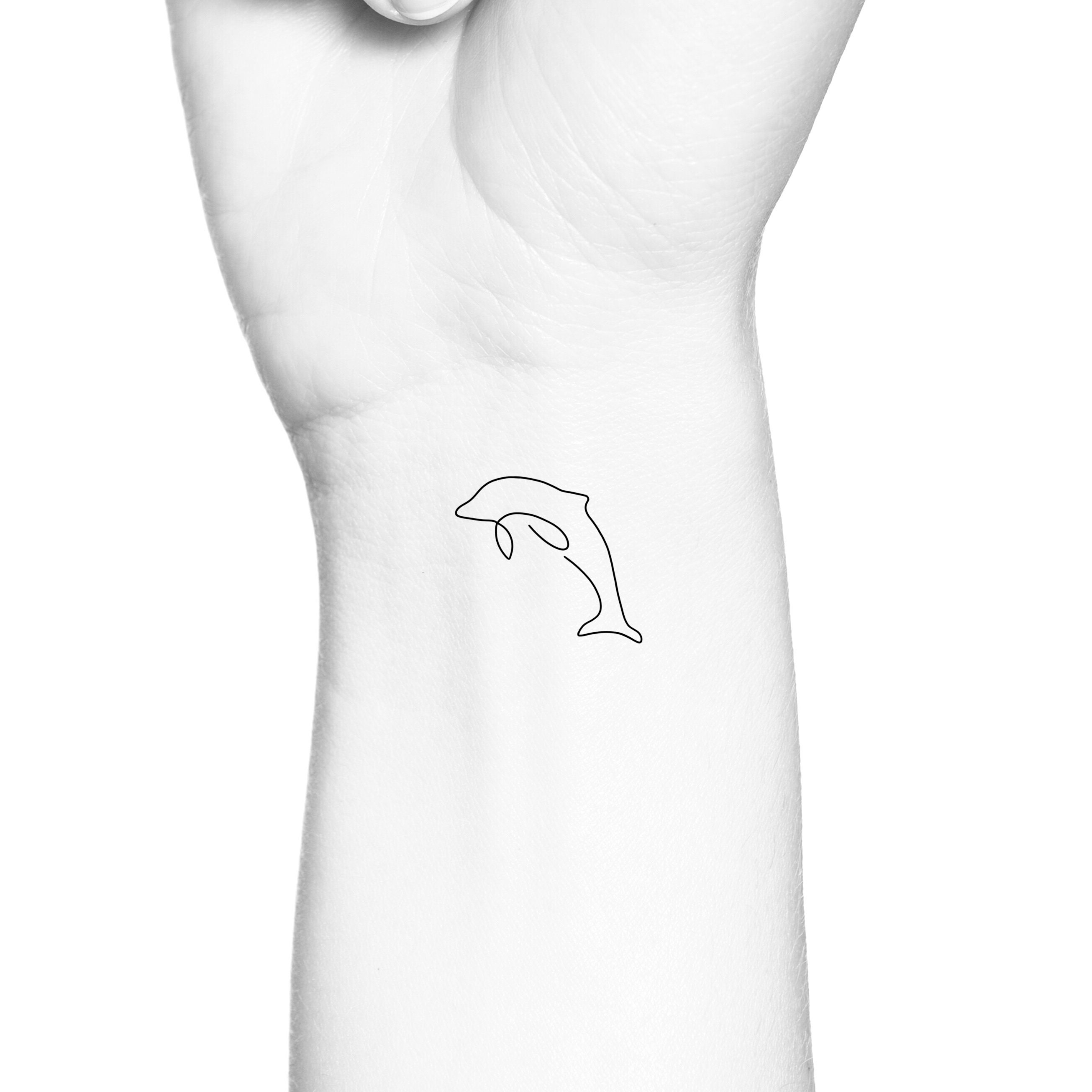 Matching dolphin tattoos by @jizottt - Tattoogrid.net