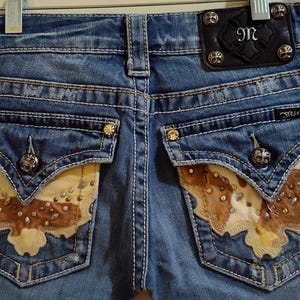 REDUCED! Miss Me Cowhide Fuzzy Flap Back Pockets Bootcut Style JW4292B6 Size 26