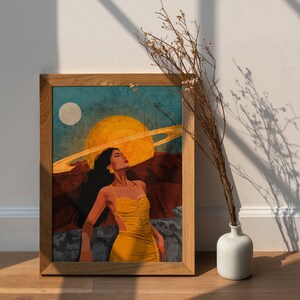 May include: A framed illustration of a woman with long dark hair wearing a yellow dress, standing in front of a large yellow sun with a ring around it. The background is a blue and brown landscape.