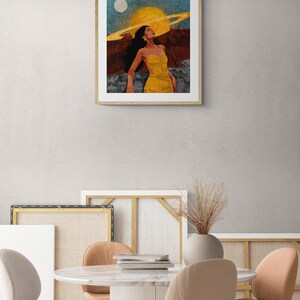 May include: A framed illustration of a woman in a yellow dress standing in a desert landscape with a large yellow sun and a ring around it in the sky. The text "SAKURA SATOH" is at the bottom of the image.