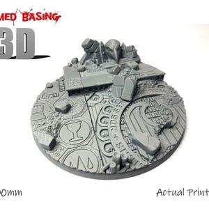 May include: A grey, 3D-printed miniature base with a detailed, textured design. The base is circular, with a diameter of 100mm (approx. 3.9 inches), and features architectural elements and engraved patterns. The text "Themed Basing" and "3D" are visible.