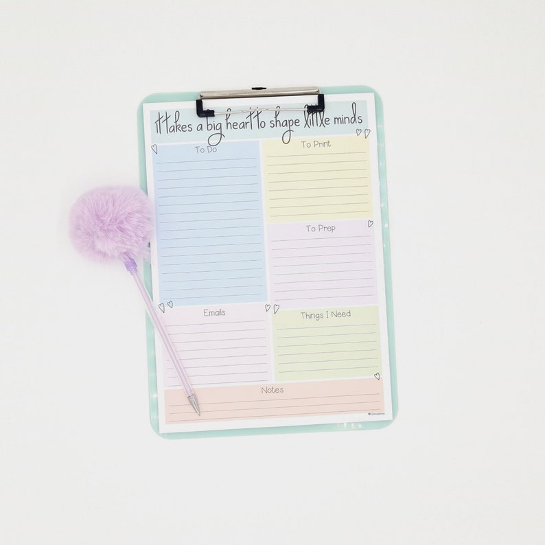 May include: A pastel colored clipboard with a checklist for to do, to print, to prep, emails, things I need, and notes. The clipboard has the text "It takes a big heart to shape little minds" at the top.