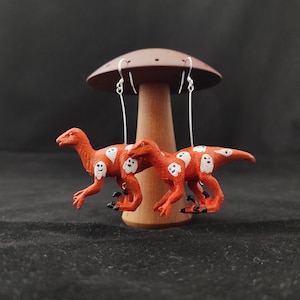 Velociraptor Dinosaur Earrings - orange with floating ghosts