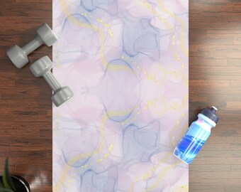 May include: A purple and blue yoga mat with gold accents. The mat is on a wooden floor with a water bottle and two dumbbells.