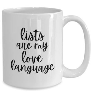 May include: White ceramic coffee mug with black text that reads "lists are my love language".