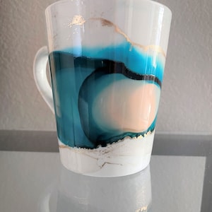 Blue, mellow peach, and gold alcohol ink mug