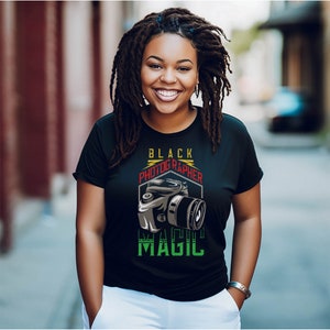 May include: Black t-shirt with a graphic of a camera and the text "Black Photographer Magic".