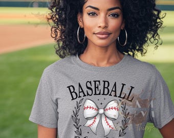 May include: A gray t-shirt with the text "Baseball Moms Club" and a white baseball-themed bow with red stitching.