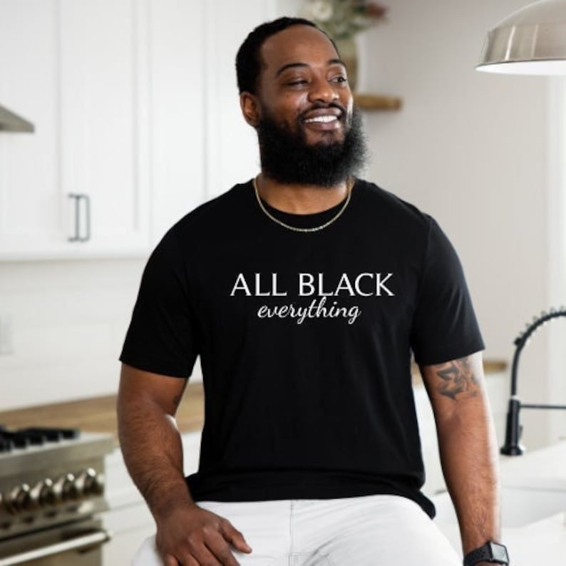 May include: A black t-shirt with the text "ALL BLACK everything" in white lettering.