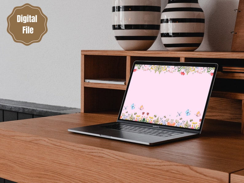 May include: A laptop computer with a pink background and a floral border with butterflies. The laptop is on a wooden desk with two striped vases.