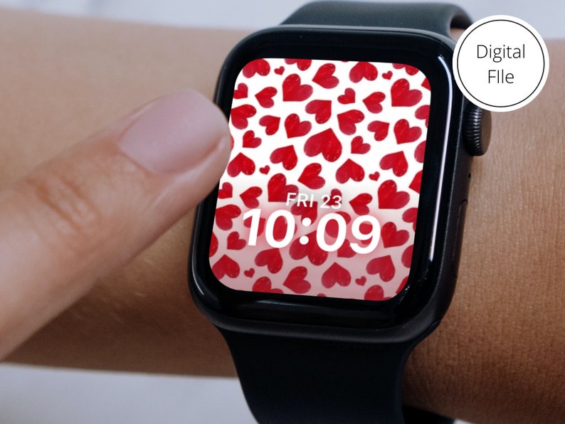 May include: A black Apple Watch with a white background and red hearts pattern. The time is 10:09 and the day is Friday the 23rd.